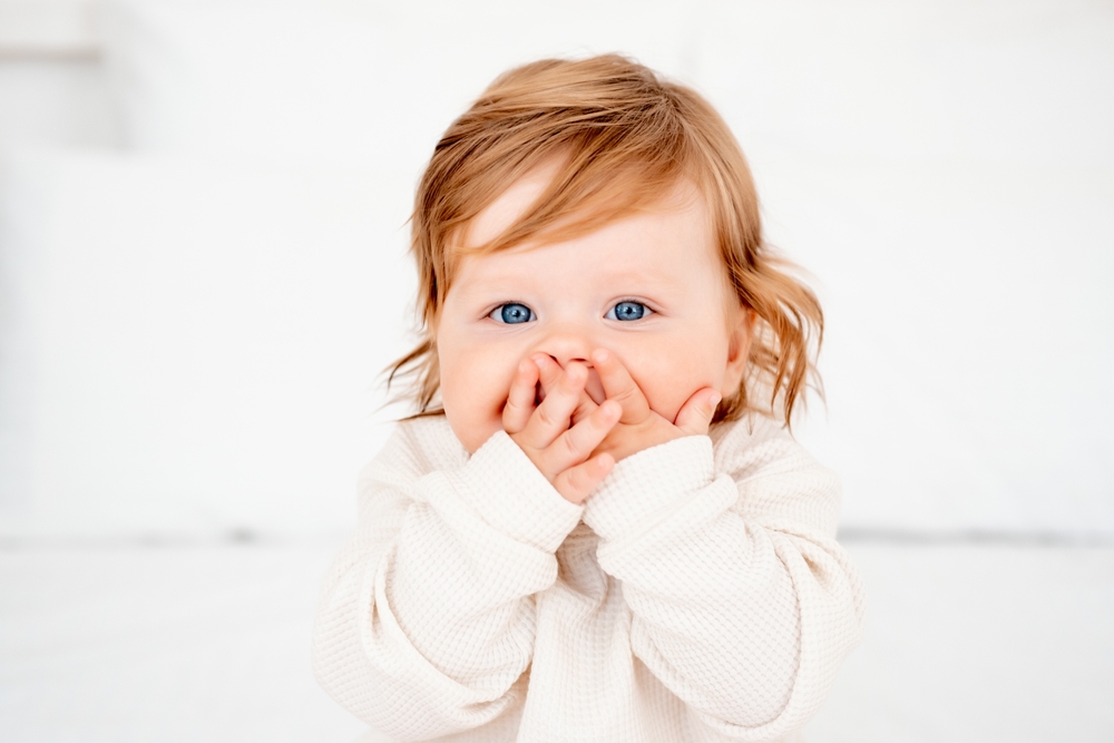 Portrait,Of,A,Surprised,Baby,With,Red,Hair,And,Blue